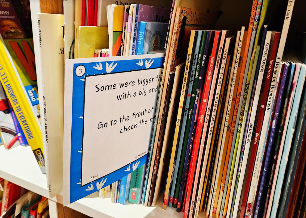 free game for kindergarten shows a riddle printed and stuck between books in a library.