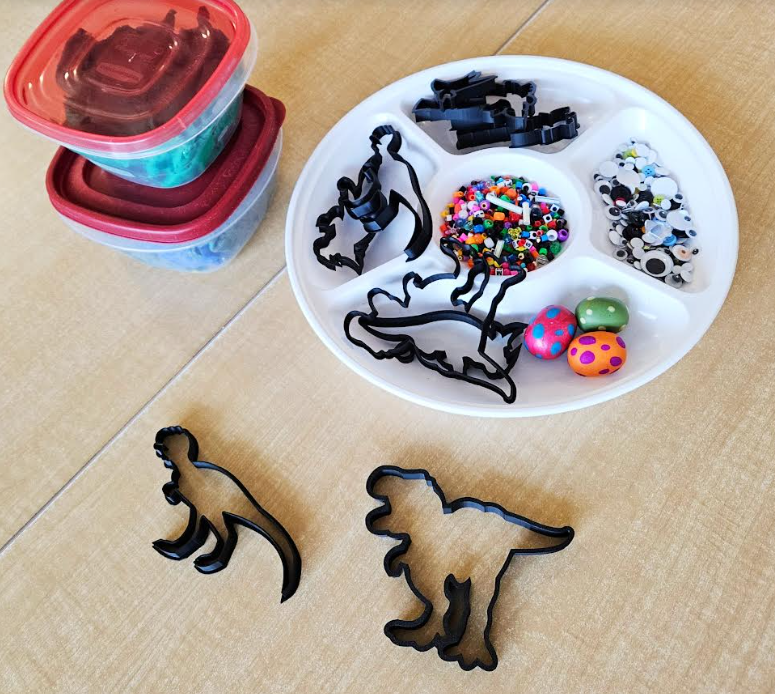 play dough activities shows dino cookie cutters and playdough for the cutters.