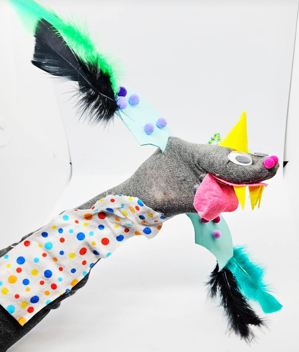 arts and crafts for kids shows a dinosaur sock puppet.