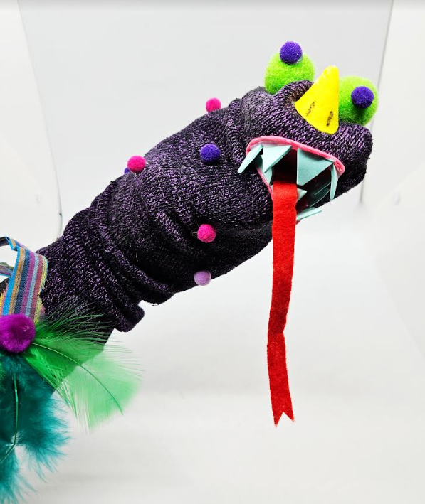 sock puppet shows a dinosaur sock puppet made by a child.