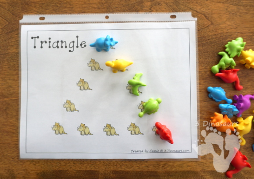 kindergarten math shows a printed page that say triangle and dino figures on each.