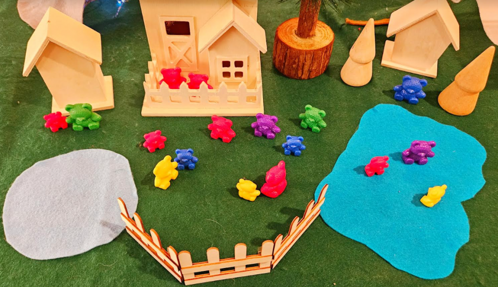 small world play shows math counting bears and wooden bird houses on a felt mat.