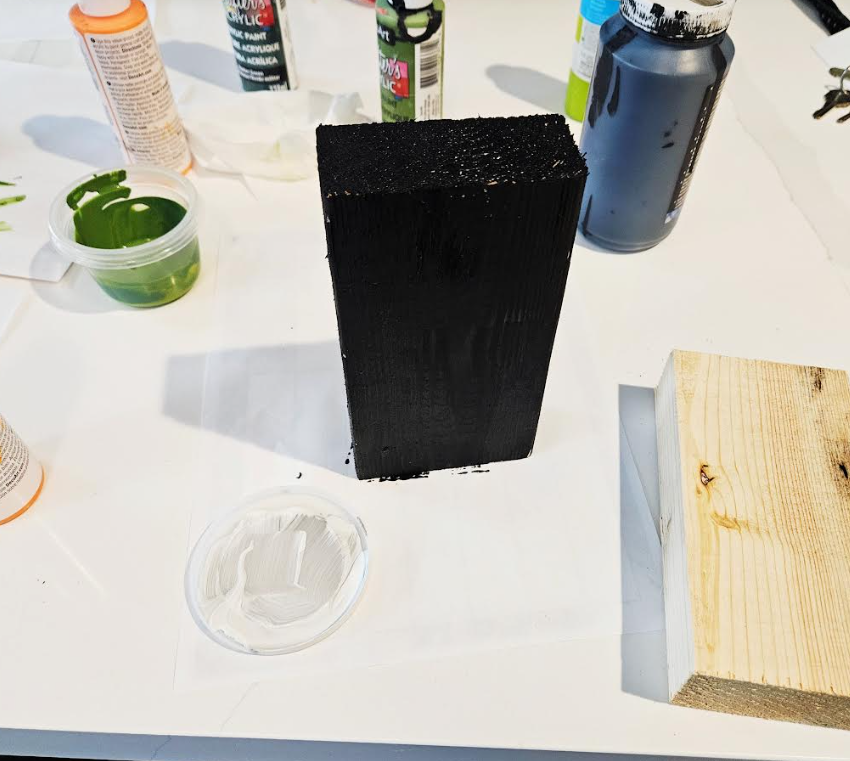 easy halloween art project shows a wooden block painted black.