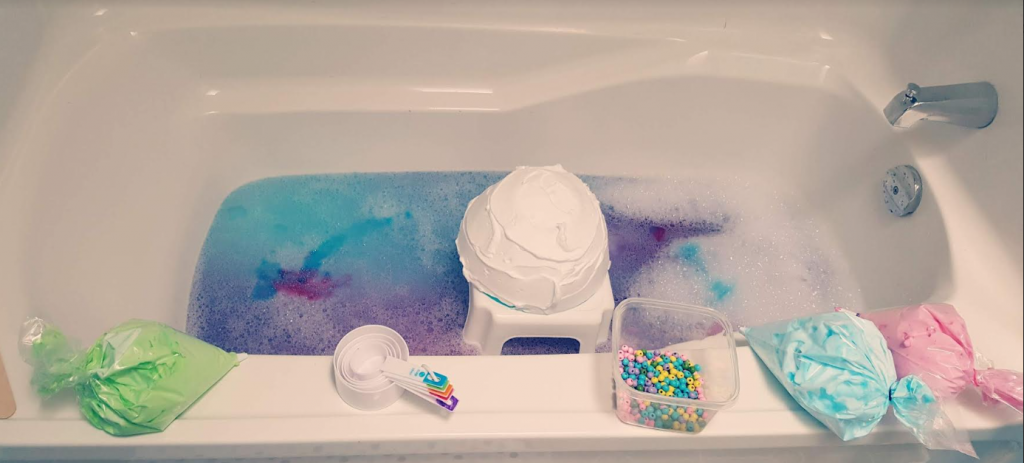 sensory activity for kids shows a bath tub with shaving cream and beads.