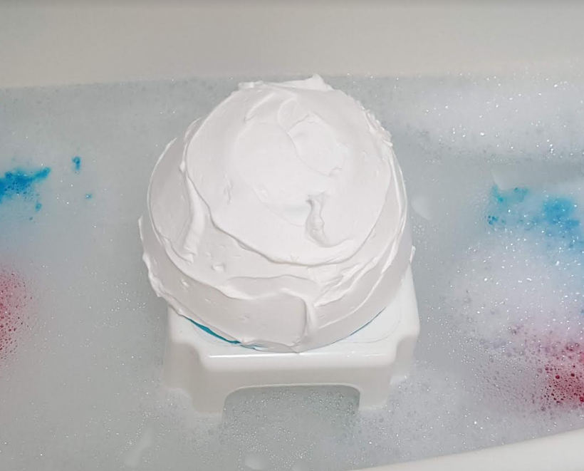 sensory activity for kids shows a bowl upside down with white shaving cream smoothed on top.