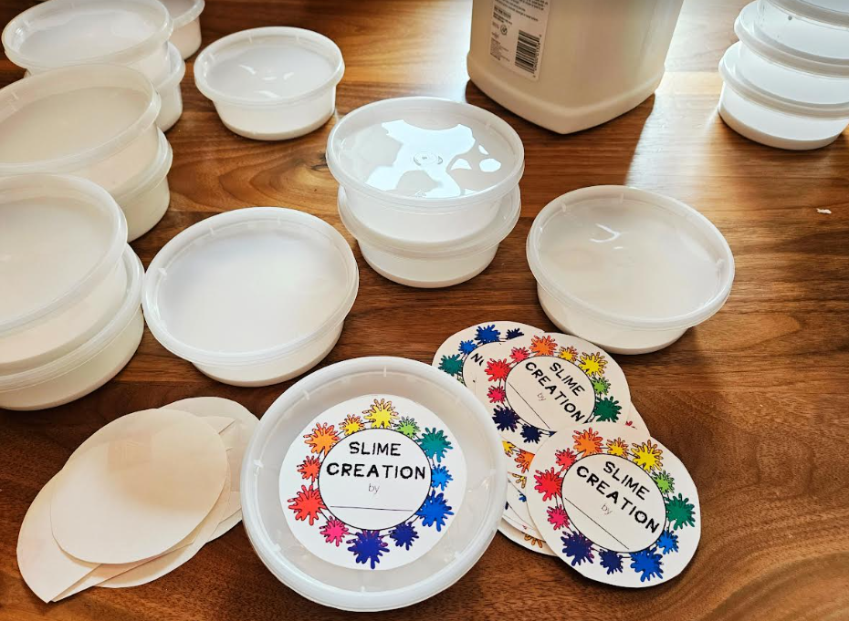 sensory play shows open containers with glue in each and a label that says slime creation on the top.