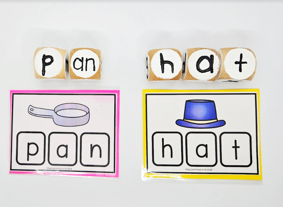 word family game shows two cards with words on each, pan and hat, and wooden blocks that spell out PAN and HAT.