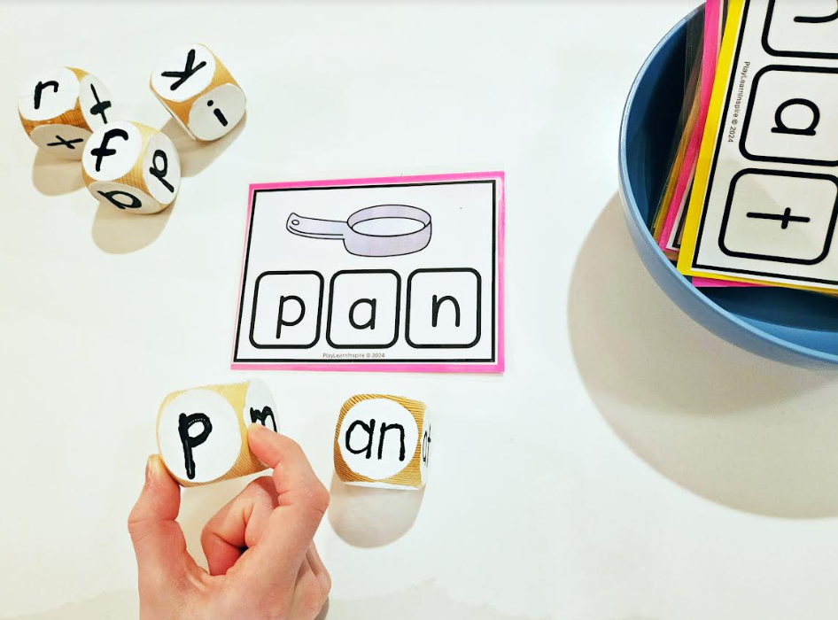 making words shows a child holding the letter P and setting it beside another block that says AN and a card that says pan.