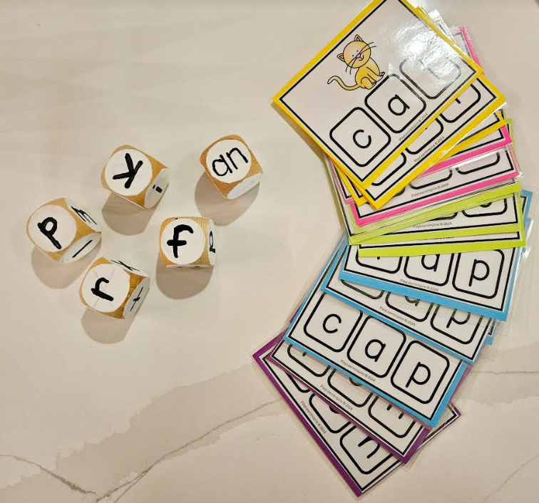 word family game shows a stack of word family cards and five blocks with letters on each side.