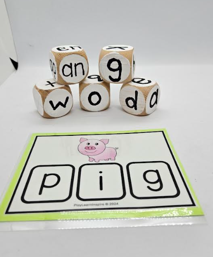 language activity for kindergarten shows an activity card that says PIG and five letter blocks with a letter on each side.