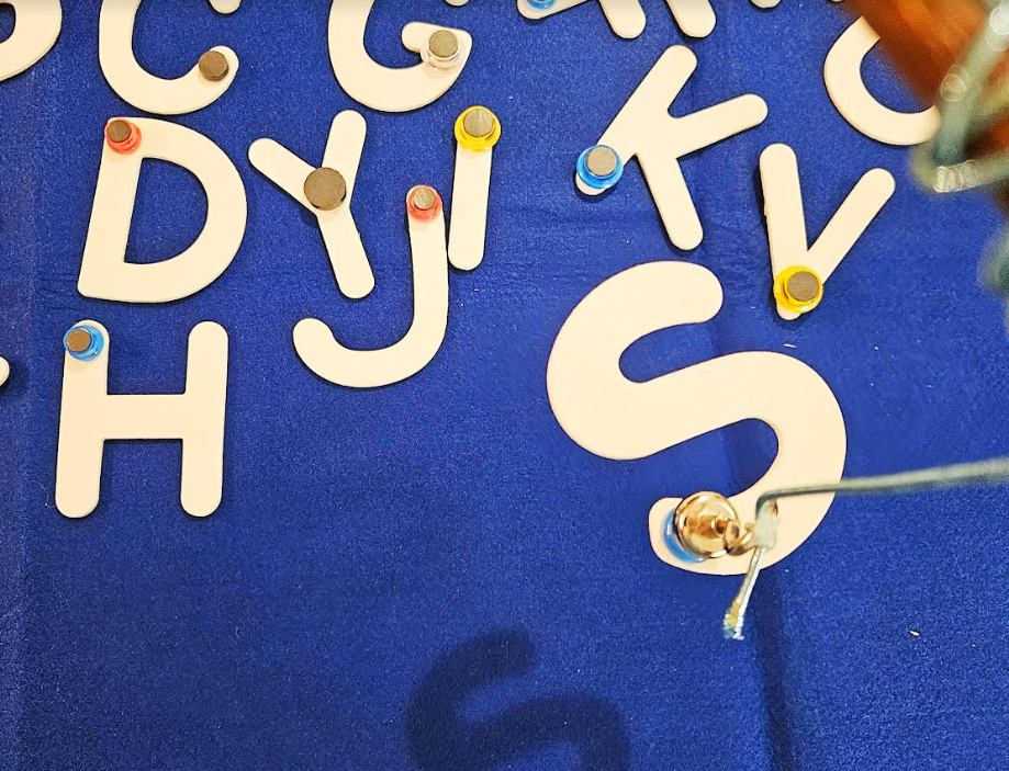 letter game for preschool shows the letter S stuck to a magnetic fishing rod.