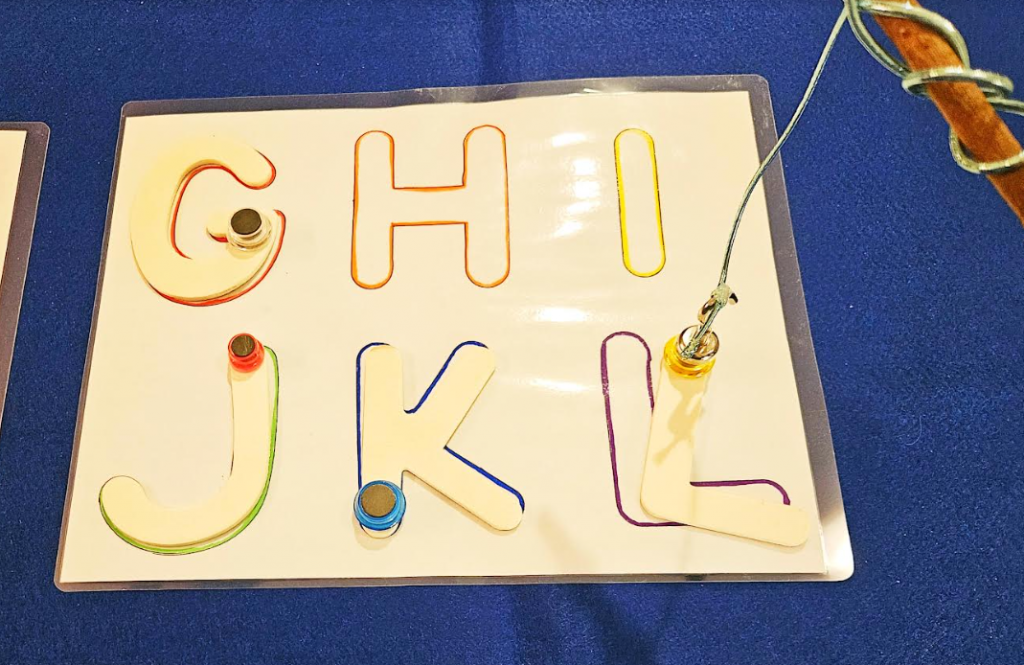 alphabet game shows a page with the letter GHIJKL and the letter L being set on the L.
