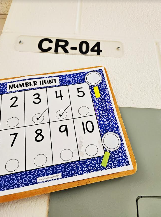 math number hunt shows a number sheet on a clipboard and a number 04 on the wall.