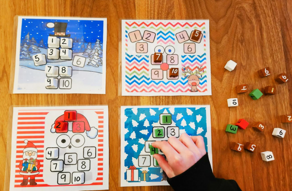 math game shows four Christmas themed printables and a child putting numbered blocks on the to create the images.