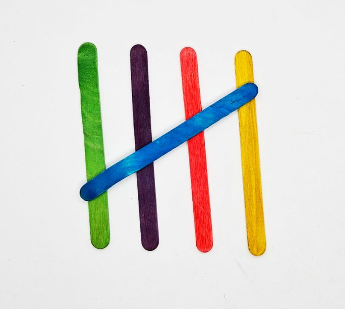 preschool math shows five popsicle sticks making tally marks.