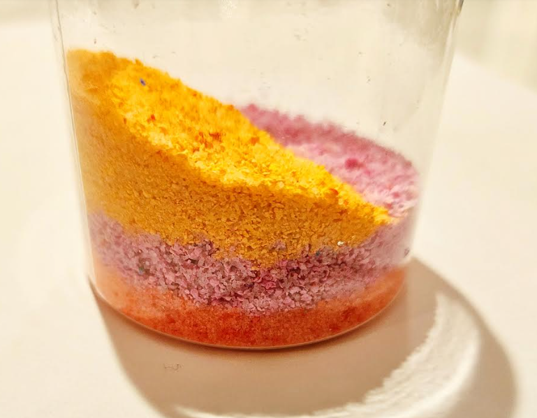 easy summer craft for kids shows a jar with layers of grated chalk.