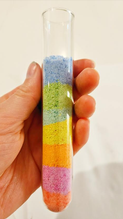 rainbow in a jar shows someone holding a jar with layers of chalk dust.