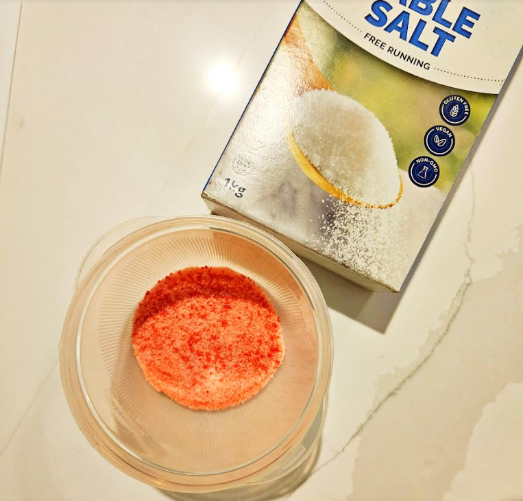 easy summer craft for kids shows a bowl with red chalk and a box of table salt.