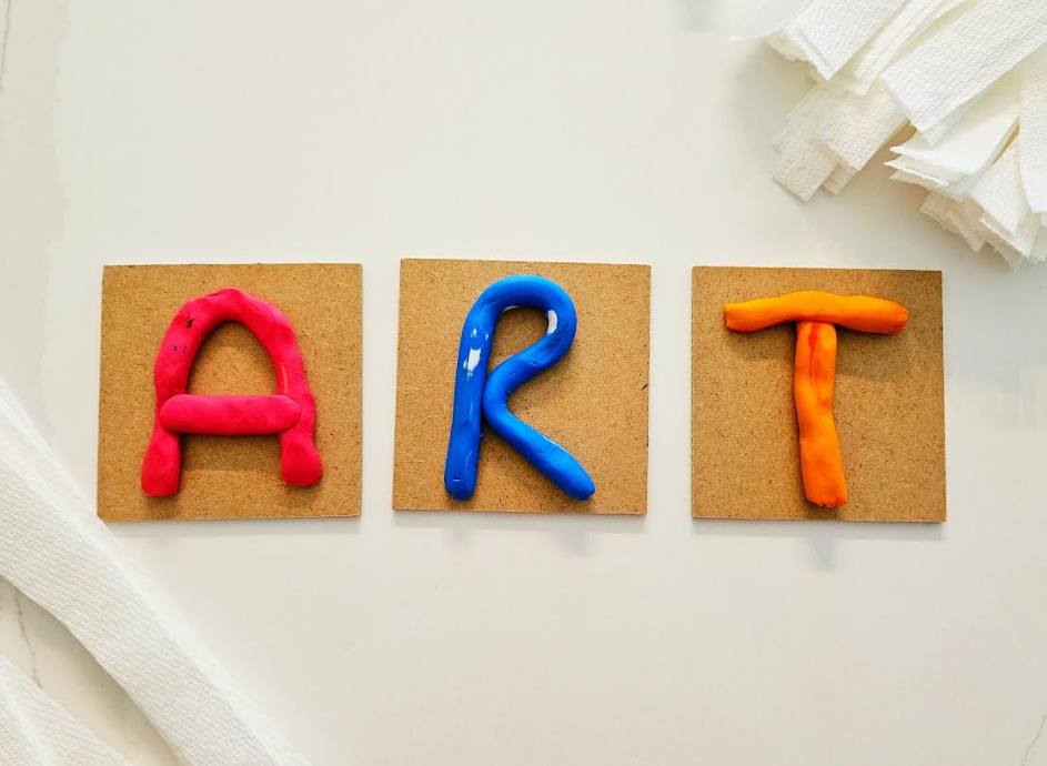 art for kids shows the letters ART on small boards made from plasticine.
