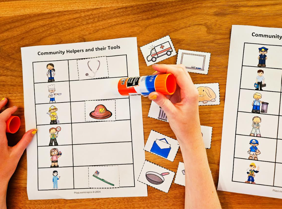 social studies for kids shows a child gluing cut outs onto a worksheet.