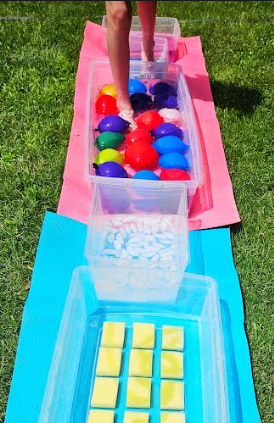 summer activity shows a child walking through water balloons.