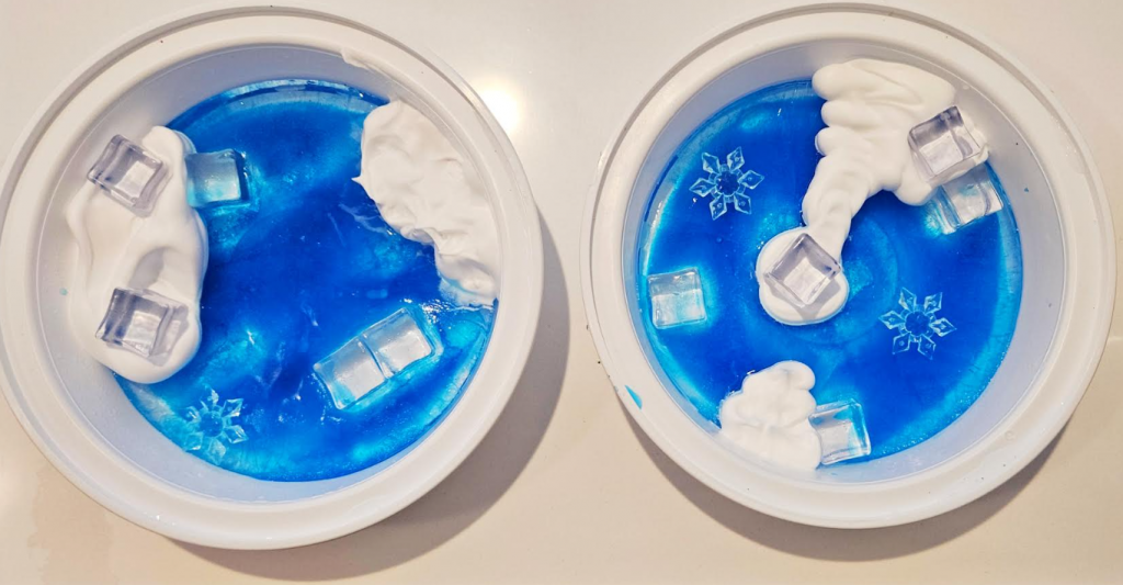 DIY winter sensory tray shows two small tray with blue frozen water and shaving cream.