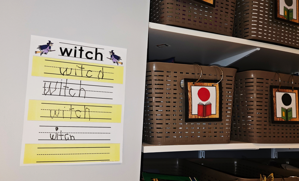 write the room activity shows a page that says "witch" beside a collection of baskets.