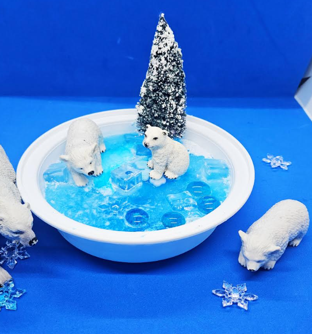 winter wonderland shows a small tray of frozen blue water and three polar bear figures and a snowy tree figure.