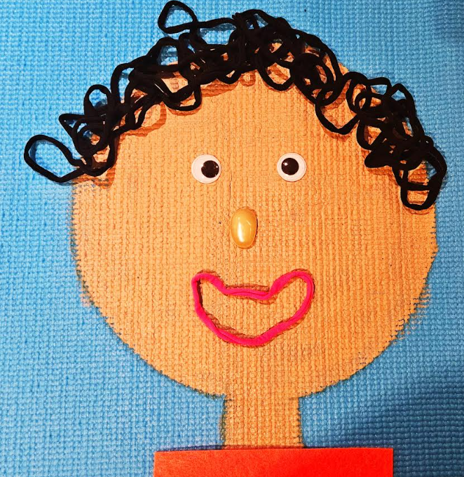 self portrait art project for young kids shows a face with the features made from loose parts.