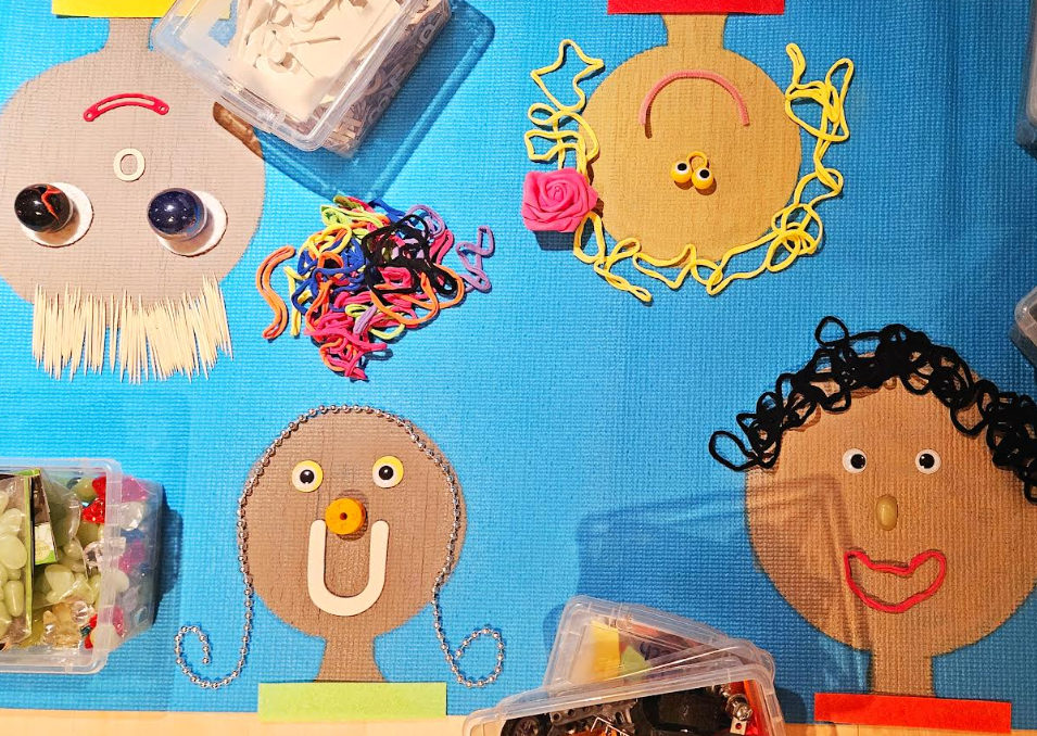 build a face art project shows four faces made from loose parts on a yoga mat.